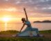 Nutrition for Yogis Eating to Support Your Practice for header photo but no writing. A woman practices yoga by the sea. nature photo